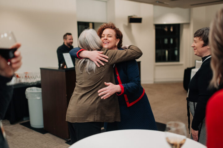 CCCE’s Grace Smith giving Magalie Dumas from L’Appui pour les proches aidants a hug