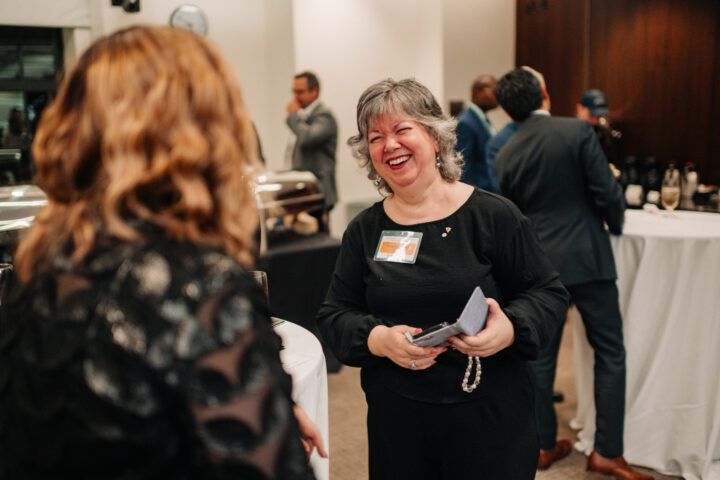 ) Lorin MacDonald speaking with an attendee